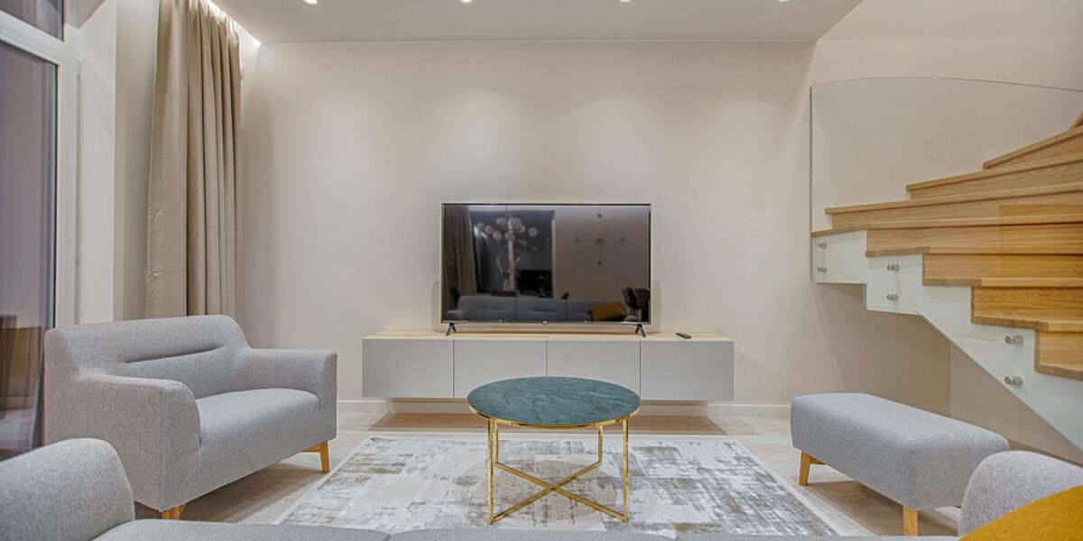 Stylish minimalist living room with modern furniture and warm lighting.