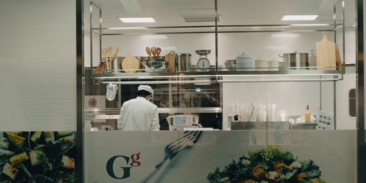 A chef cooking in a modern kitchen at night in Toyohashi, Japan.