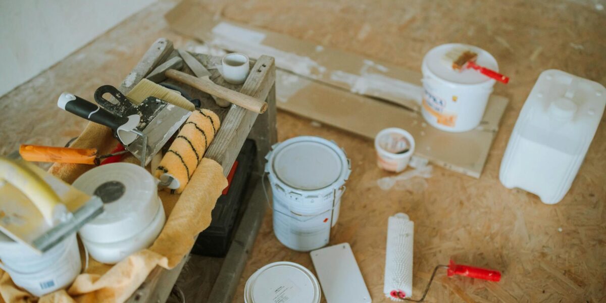 Overhead shot of tools and paint supplies for a home renovation project.
