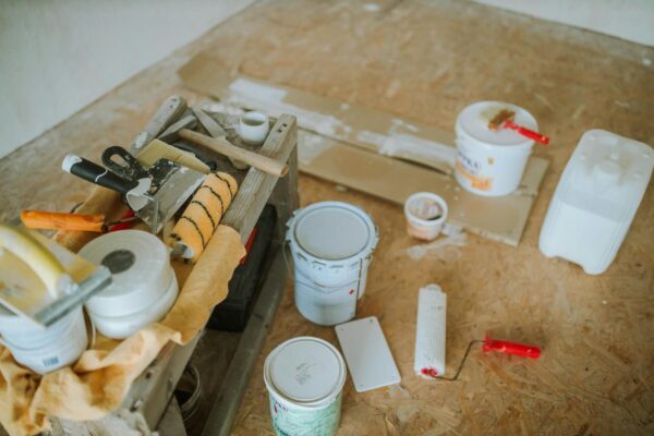 Overhead shot of tools and paint supplies for a home renovation project.