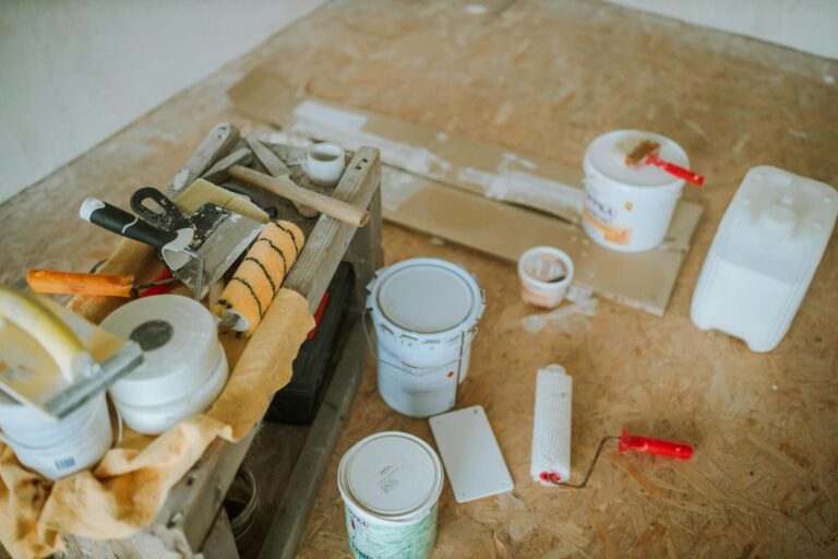 Overhead shot of tools and paint supplies for a home renovation project.