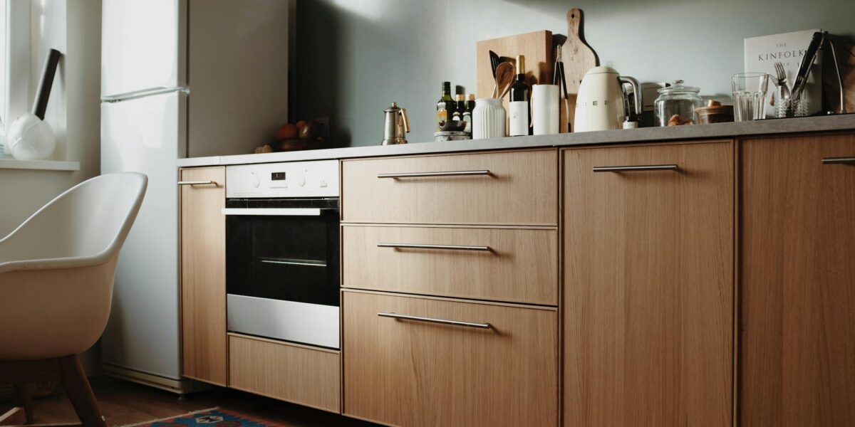 Beautiful modern kitchen featuring sleek wooden cabinets and appliances.