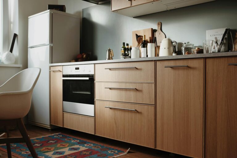 Beautiful modern kitchen featuring sleek wooden cabinets and appliances.