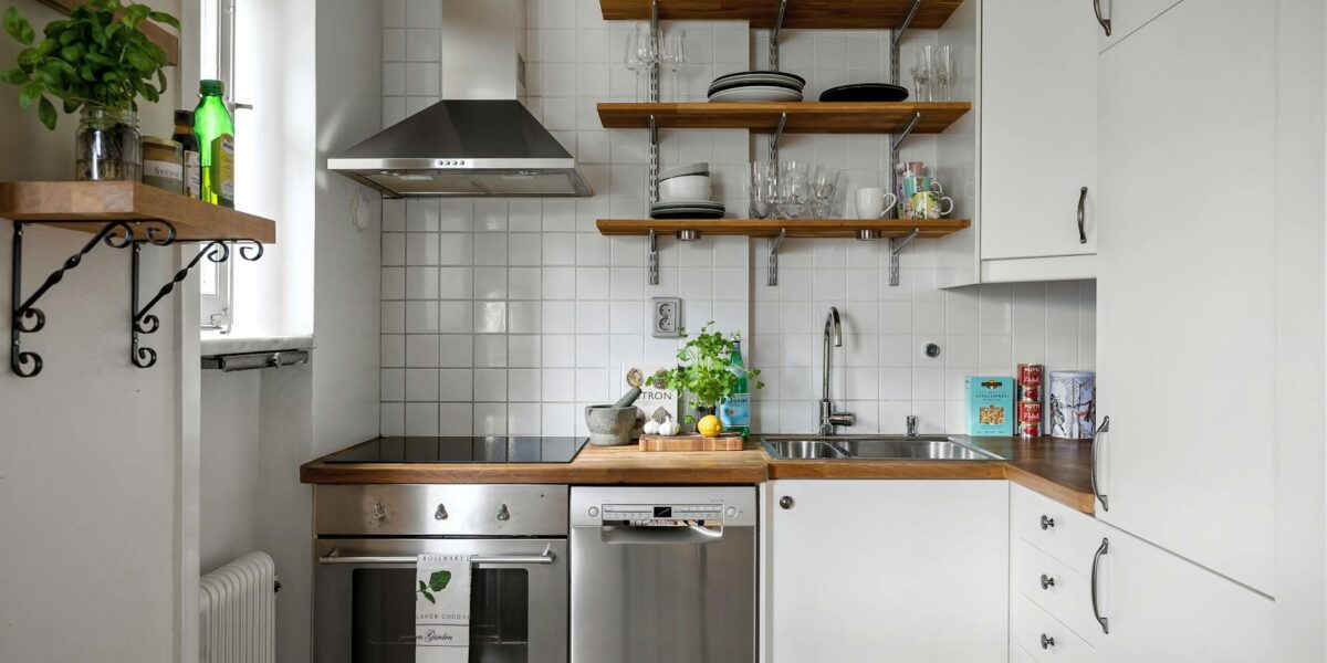 Contemporary small kitchen featuring stainless steel appliances and open shelving.
