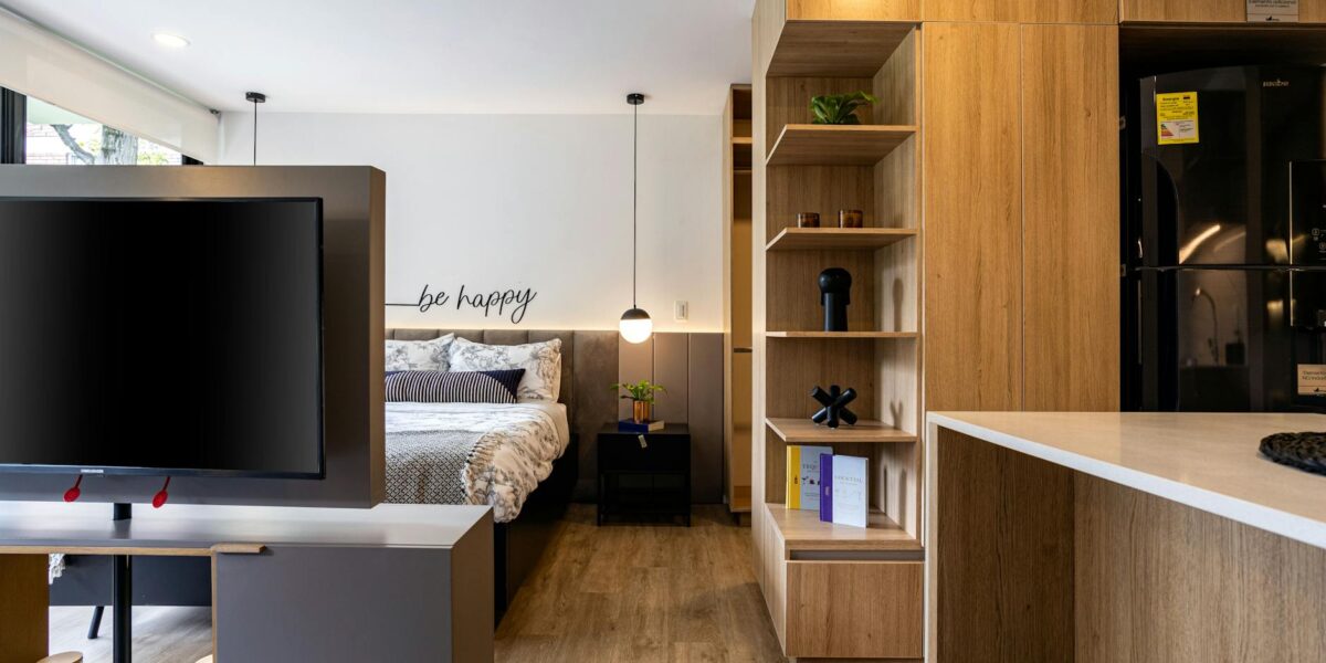 Cozy and stylish studio apartment interior design in Bogotá with wooden accents.