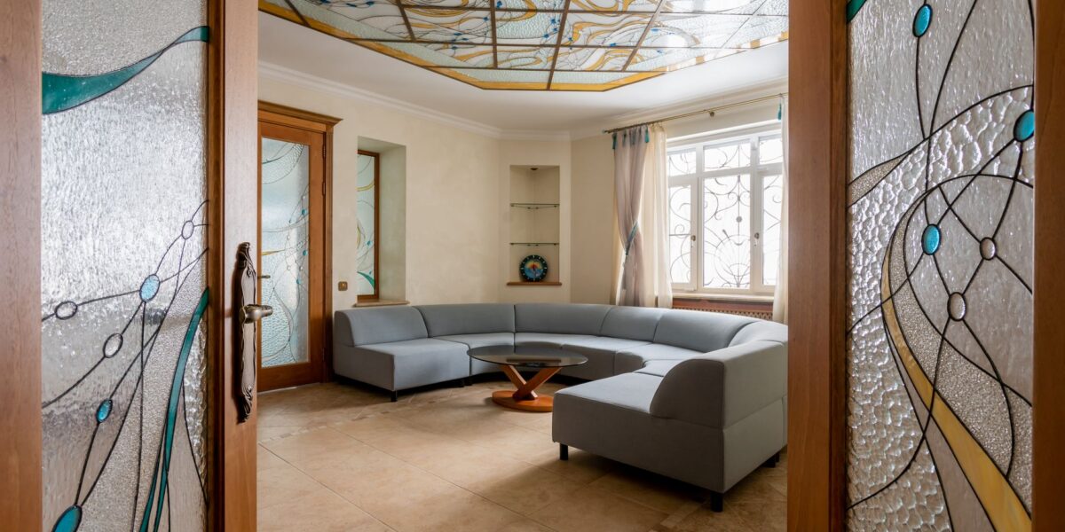 Elegant living room featuring a stained glass ceiling and modern interior design.