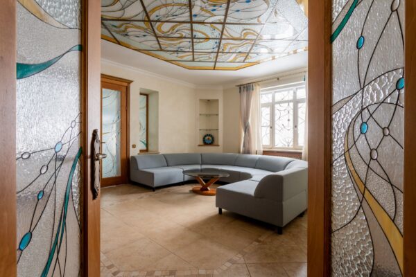 Elegant living room featuring a stained glass ceiling and modern interior design.