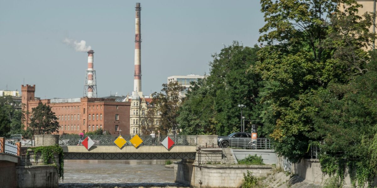Industrial chimneys and bridge over the Odra River in Wrocław, Poland.
