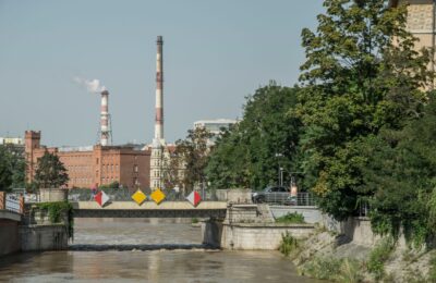 Industrial chimneys and bridge over the Odra River in Wrocław, Poland.