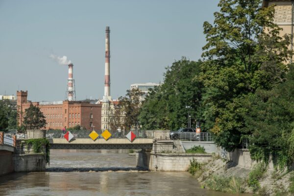 Industrial chimneys and bridge over the Odra River in Wrocław, Poland.