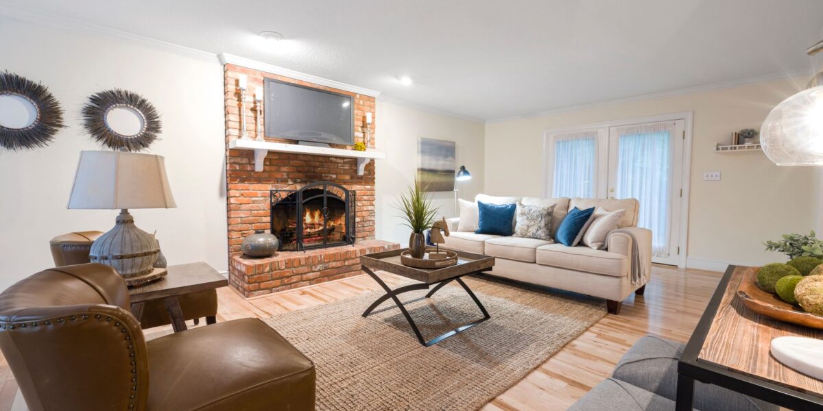 Inviting living room featuring cozy seating, brick fireplace, and stylish decor.