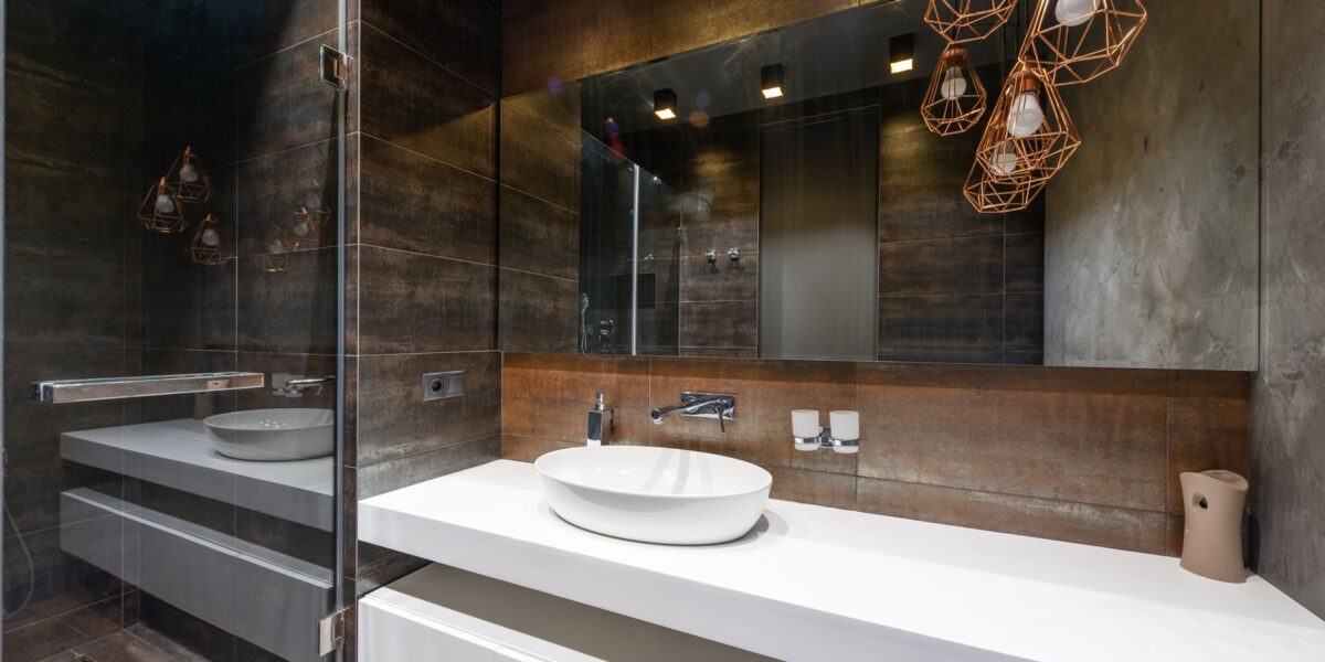 A sleek modern bathroom featuring pendant lighting and a contemporary sink.