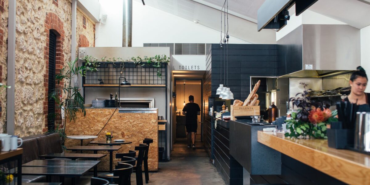 Contemporary restaurant with comfortable interior with chairs and tables near counter in daytime