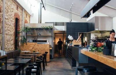 Contemporary restaurant with comfortable interior with chairs and tables near counter in daytime