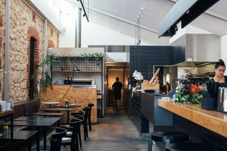 Contemporary restaurant with comfortable interior with chairs and tables near counter in daytime