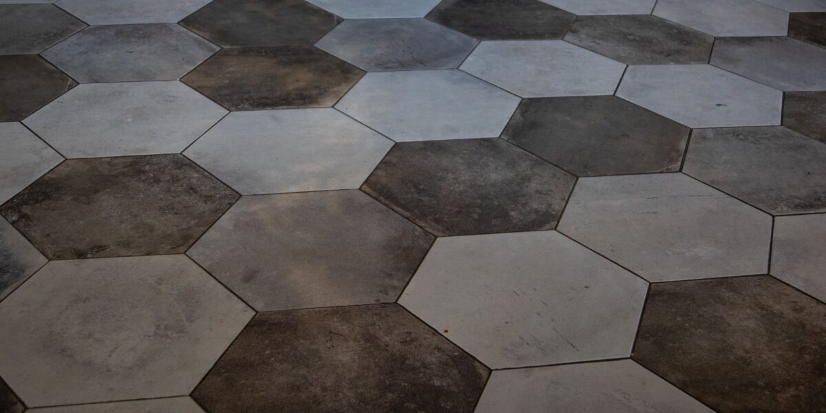Elegant hexagonal floor tiles create a striking marble pattern, perfect for modern interiors.