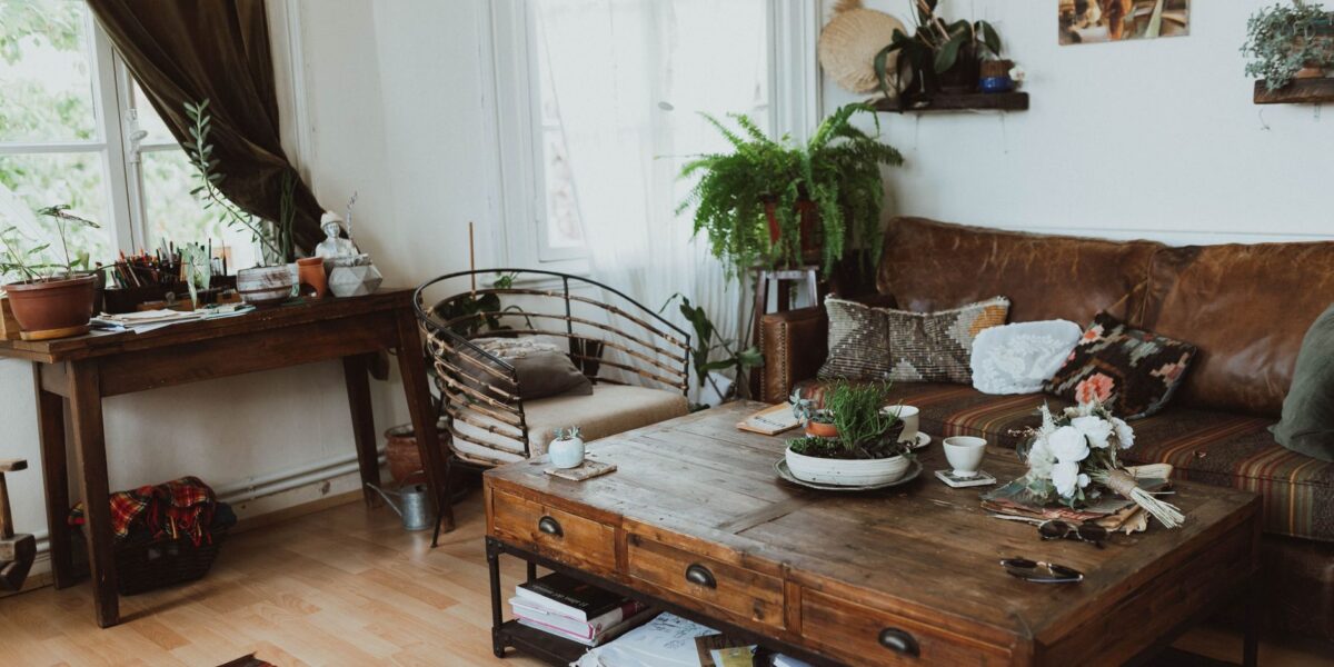 A cozy living room with vintage furniture, rustic decor, and indoor plants creating a warm ambiance.