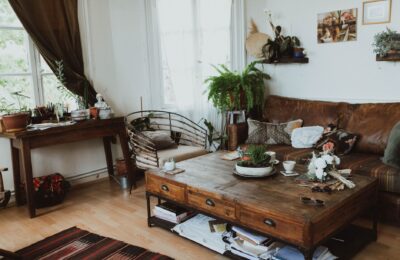 A cozy living room with vintage furniture, rustic decor, and indoor plants creating a warm ambiance.