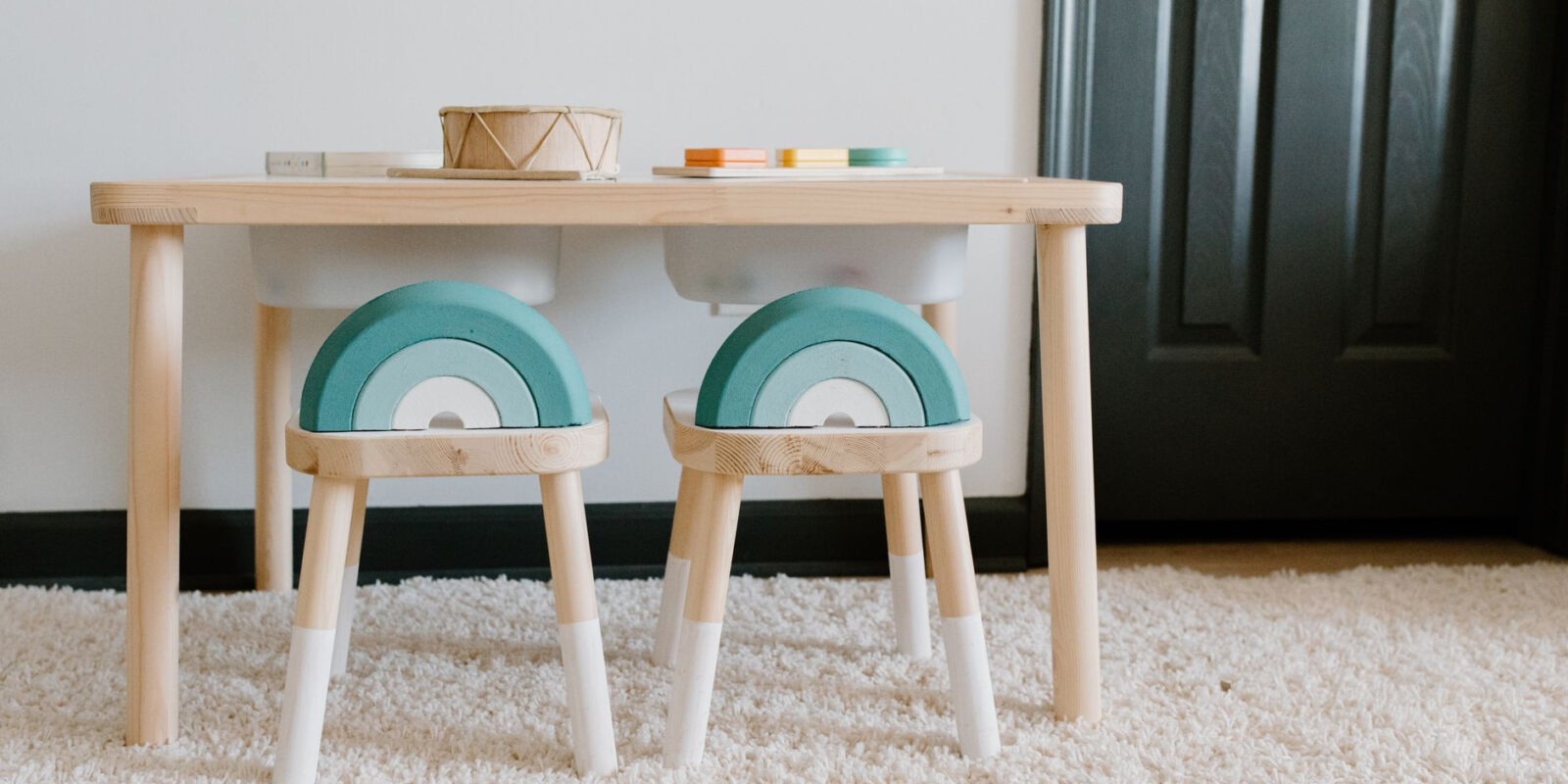 Bright playroom featuring wooden furniture and educational toys for children. Ideal for sustainable learning.