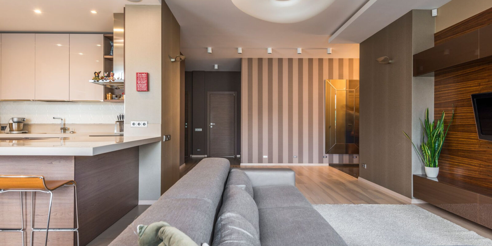 Spacious living room with a modern, minimalist design and open kitchen layout.