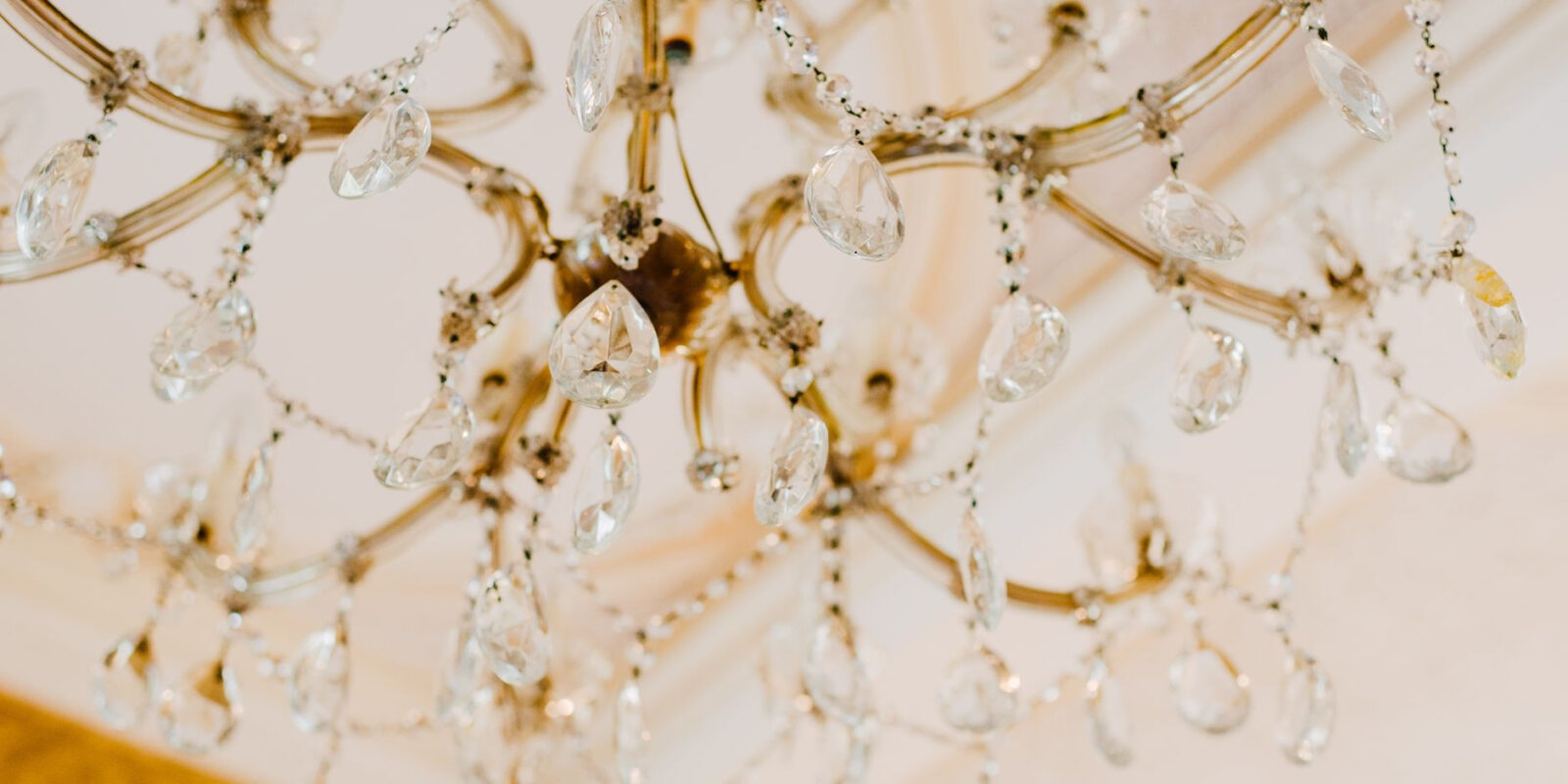 Luxurious gold and crystal chandelier showcasing elegance and glamour.
