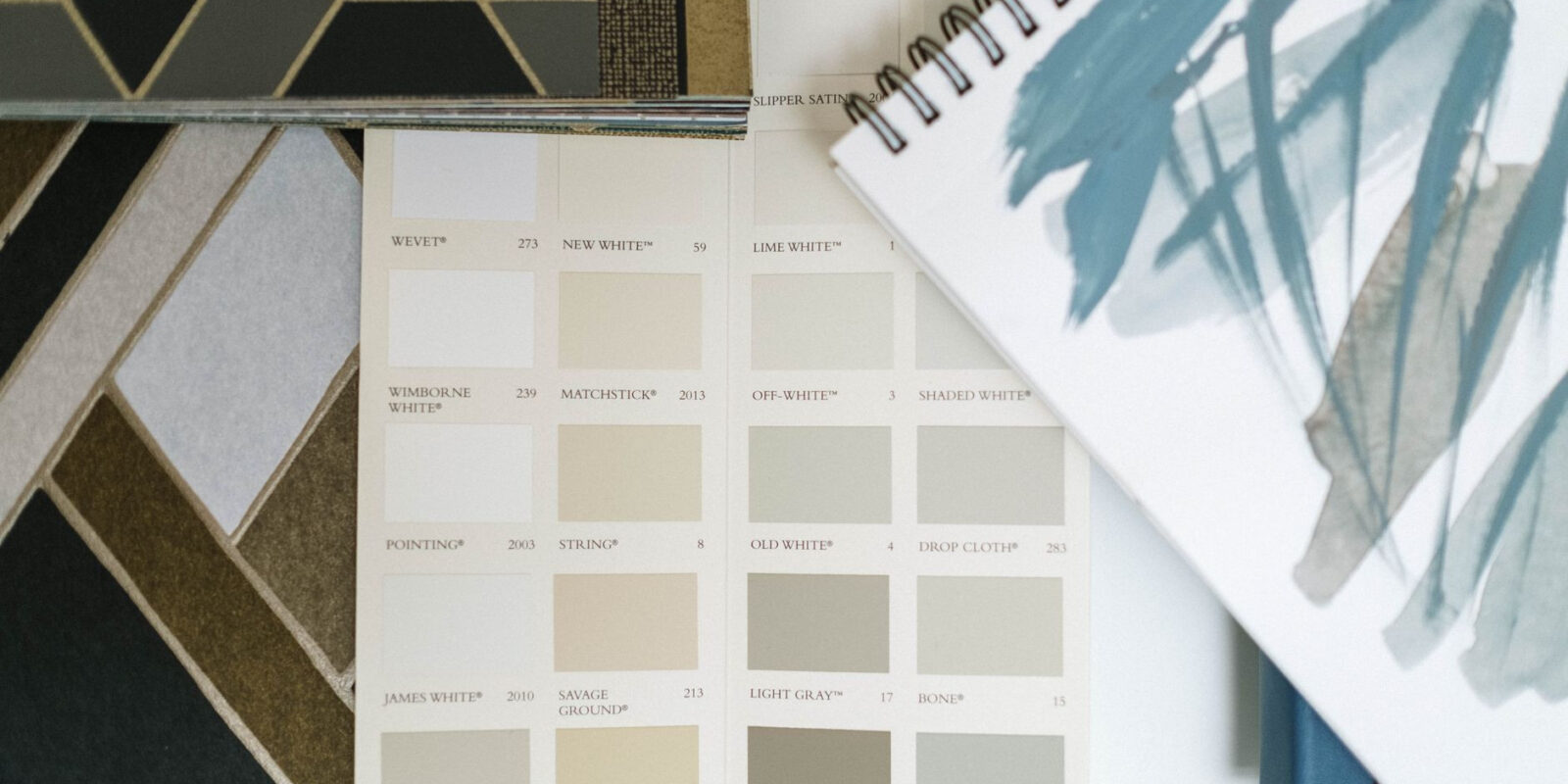 Top view of color swatches and design notebook showcasing elegant interior design elements.