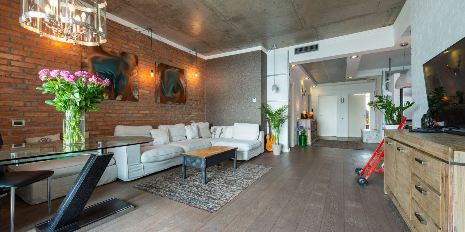 Spacious modern loft living room with elegant décor and industrial design elements.